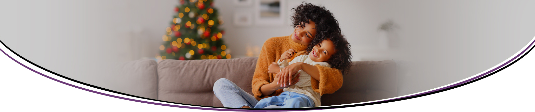 Father and daughter on couch under blanket